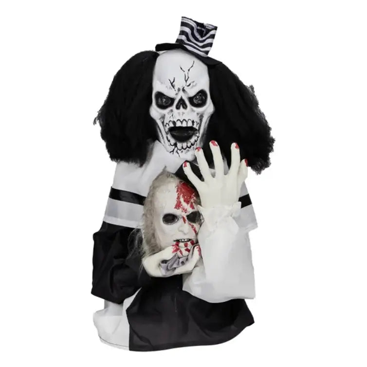 Scary clown halloween decoration 1.8ft with a black and white skull face, black curly hair, striped hat, red painted fingernails holding a bloody doll head and sound activated features.