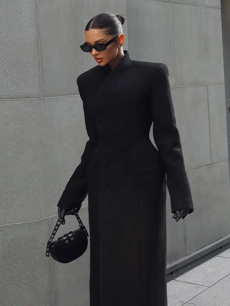 black leather mini handbag with studded strap and circular design paired with charcoal gray wool coat women waisted long outerwear