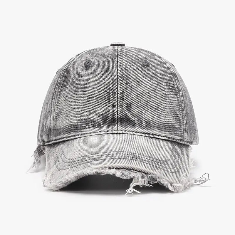 A distressed denim baseball cap in gray with frayed edges and a faded worn look.