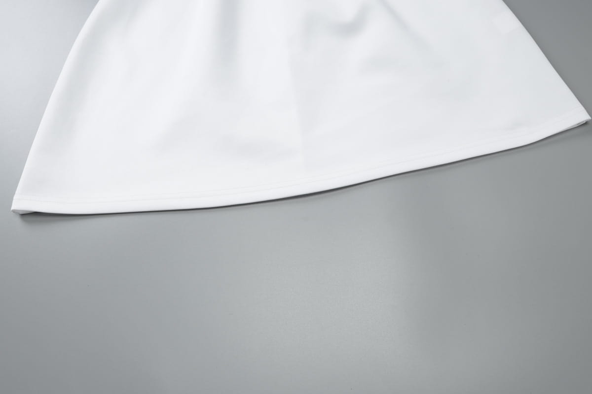 a crisp white bodycon mini dress featuring sequined off-the-shoulder design with smooth, flowing fabric and a clean hemline