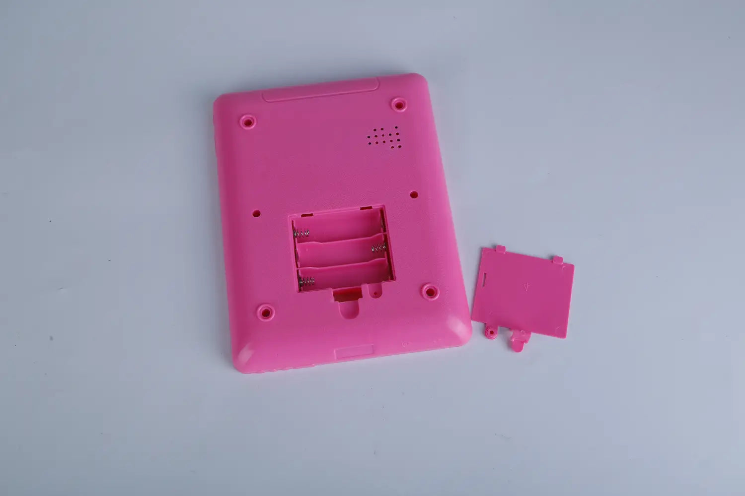 pink plastic baby learning tablet educational toy for toddlers with removable battery cover shown from the back side