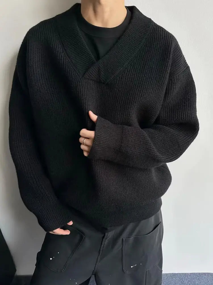 Black ribbed knit relaxed v-neck pullover sweater with an oversized fit and soft material.