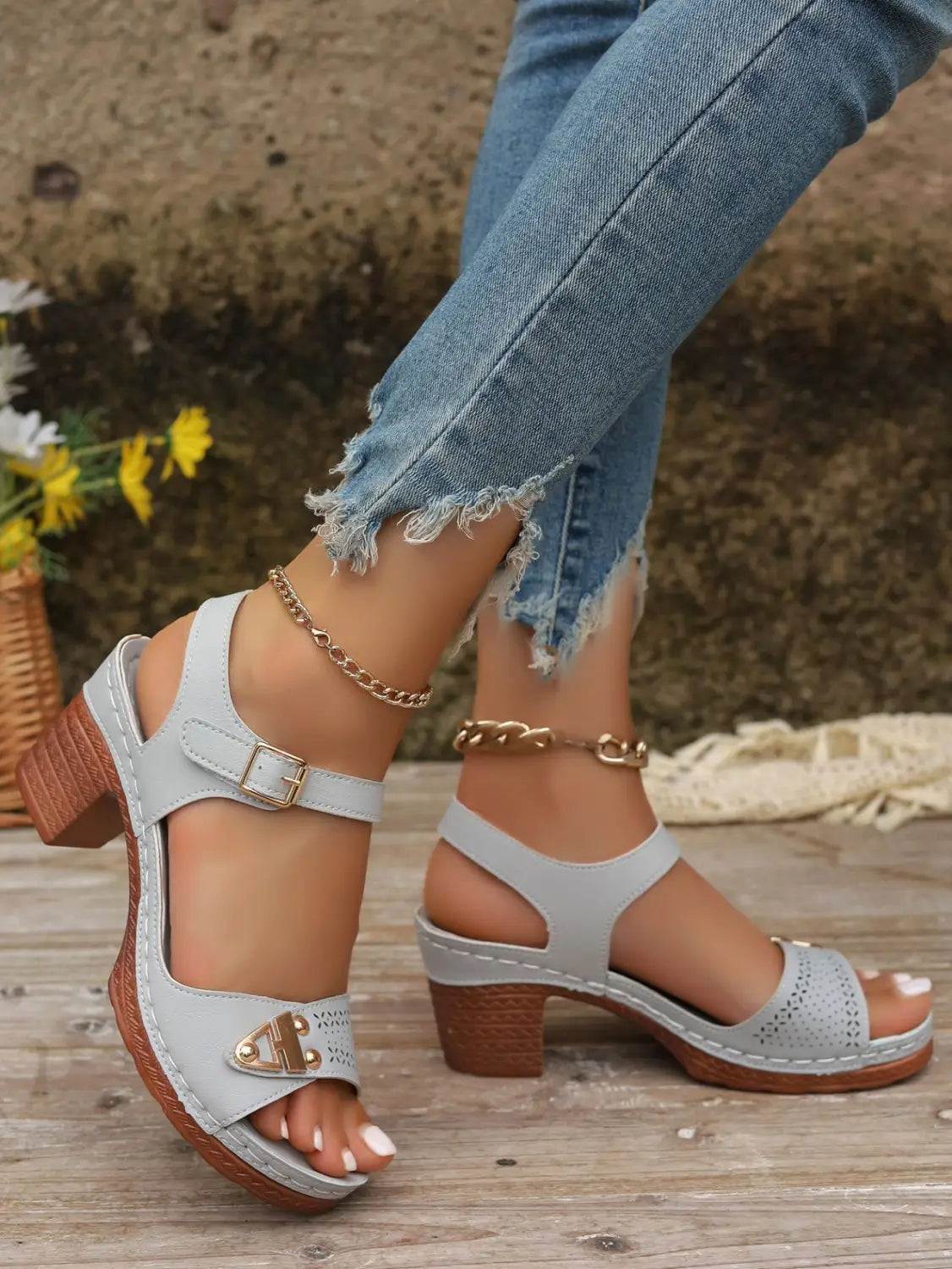 Light gray perforated leather chunky heel sandals with gold-tone buckle accents and pigskin lining.