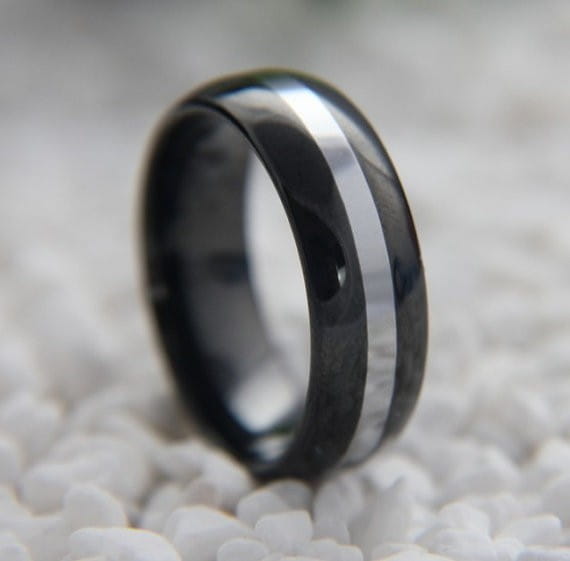 Black ceramic wedding band with a sleek polished silver stripe down the center featured as a black tungsten wedding ring with green aluminum 8mm.