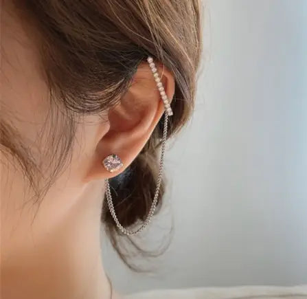 Silver pearl ear cuff with a dangling chain and a sparkling stud earring in butterfly and diamond alloy earring and ear cuff set.