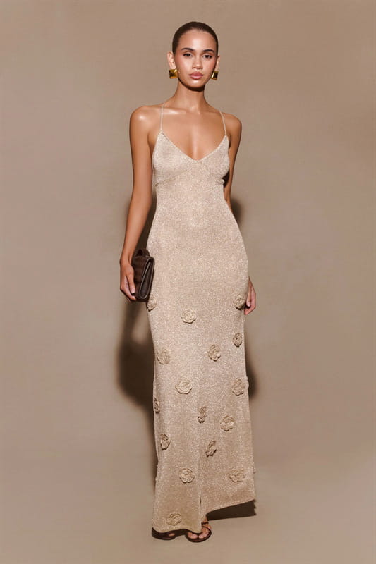 A beige crochet floral lace mermaid maxi dress with long sleeves, delicate floral embroidery, glitter accents, and a v-neckline.