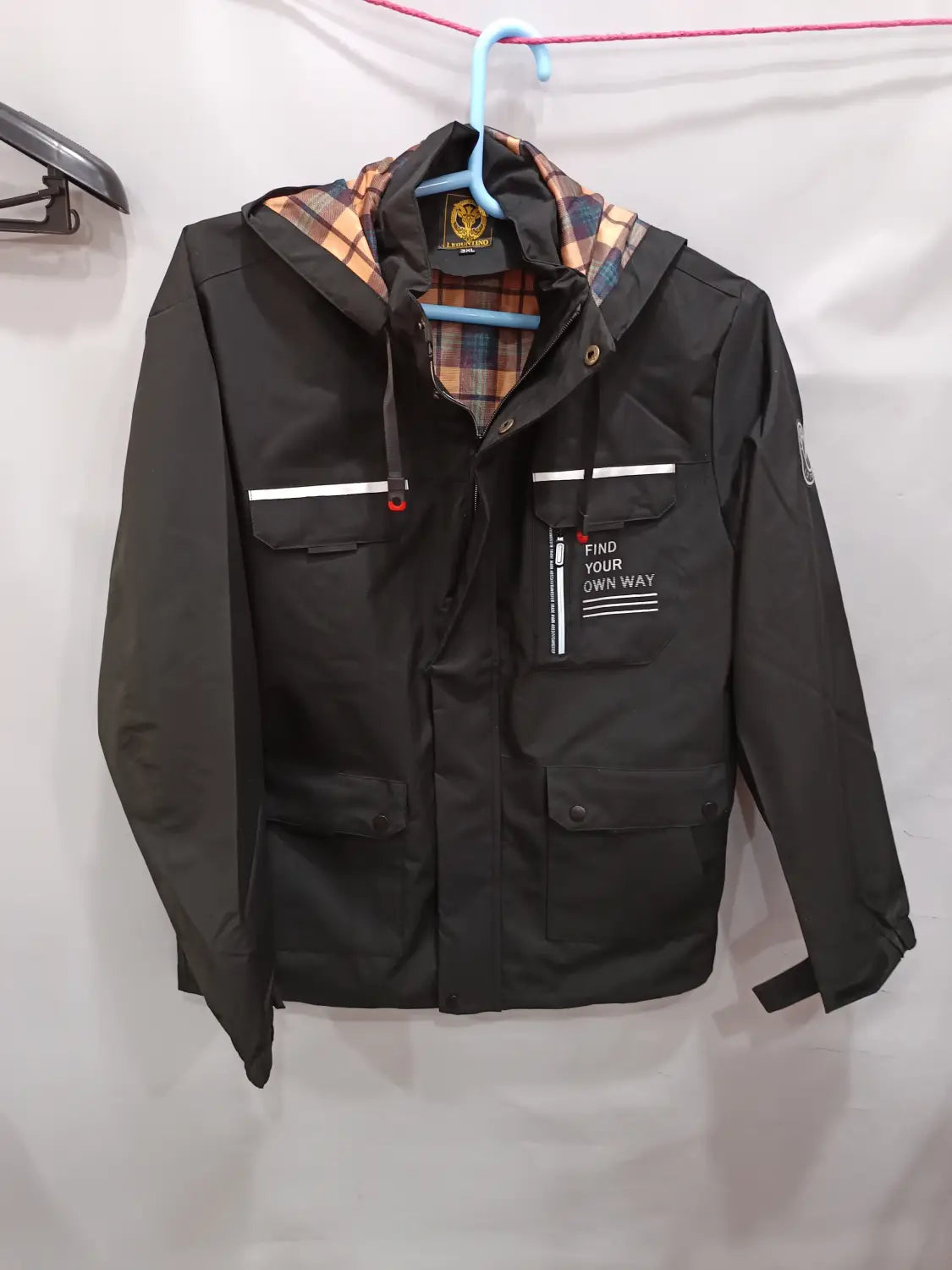 Men winter hooded parka coat in black with plaid lining and white stripe accents.