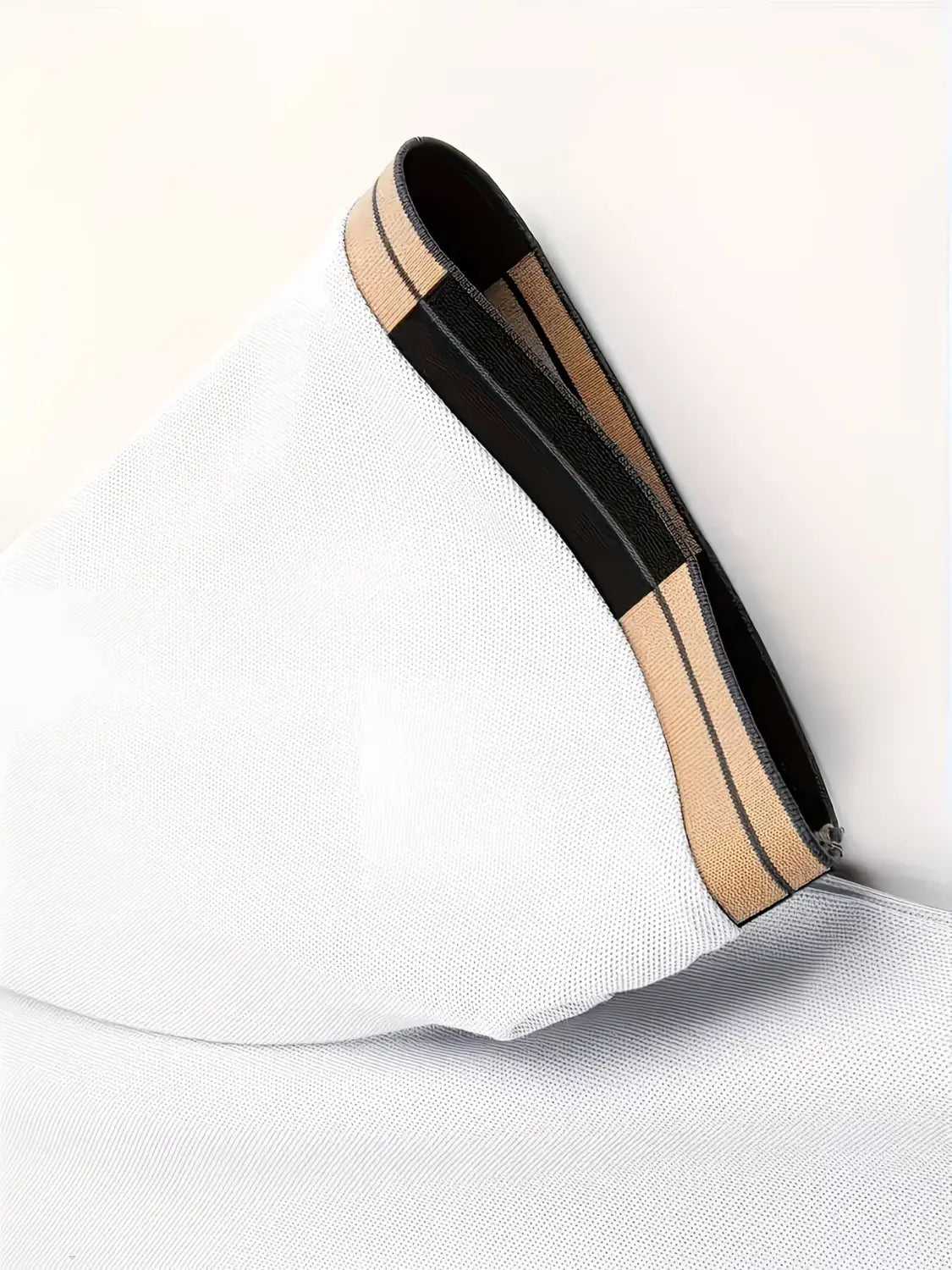 white mesh fabric bag with black and beige striped zipper trim paired with mens slim fit striped polo shirt.