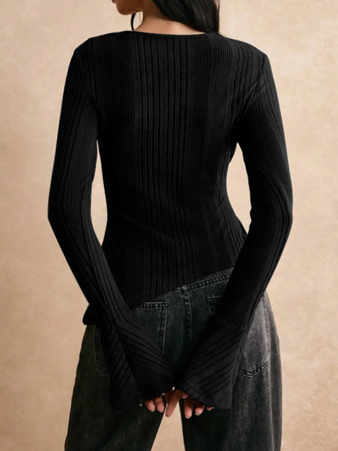 Black ribbed long sleeve cutout top with a flattering fit and flared cuffs made from soft stretch fabric.