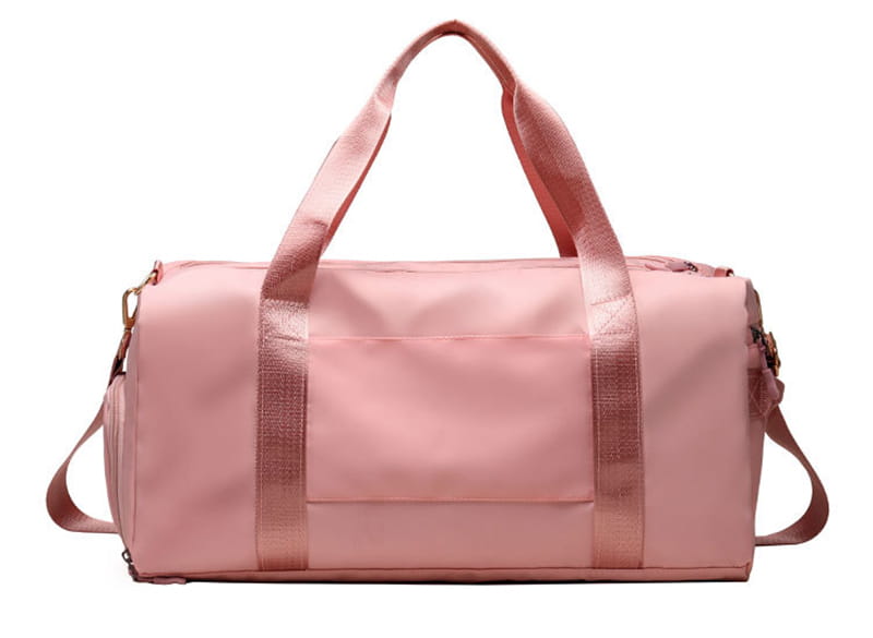 Pink waterproof oxford travel duffel bag with matching handles, detachable shoulder strap, and gold-tone zippers designed for gym and sports.