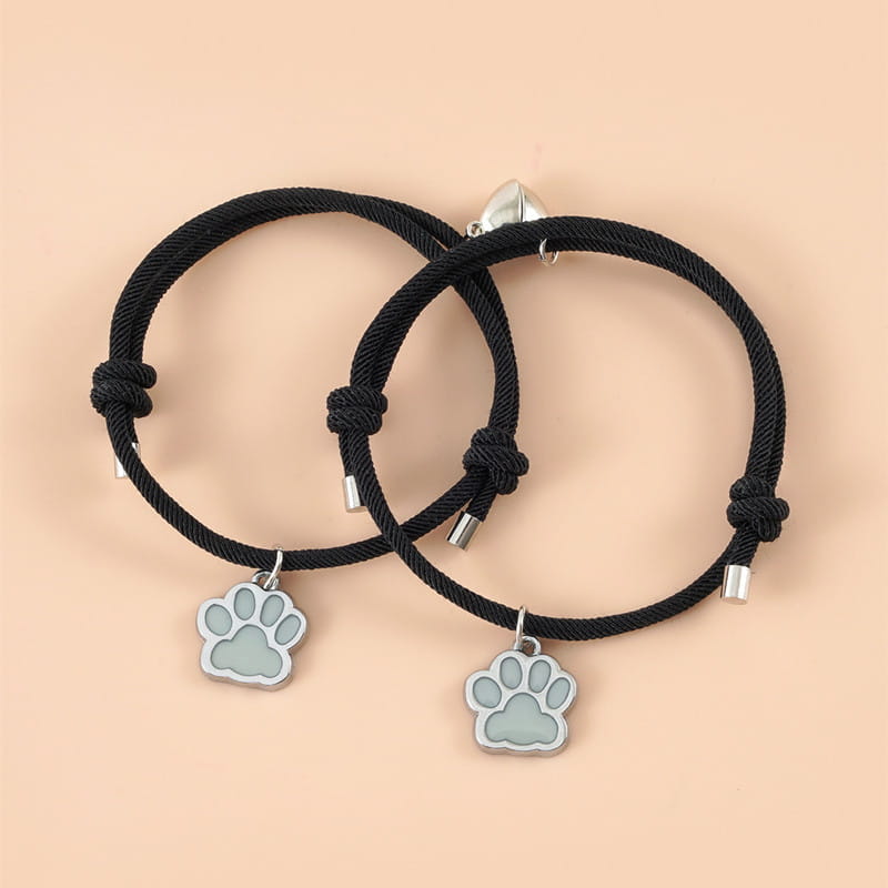 Black cord bracelet with a silver paw print charm from the luminous magnetic heart paw print couple bracelets 2pcs set.