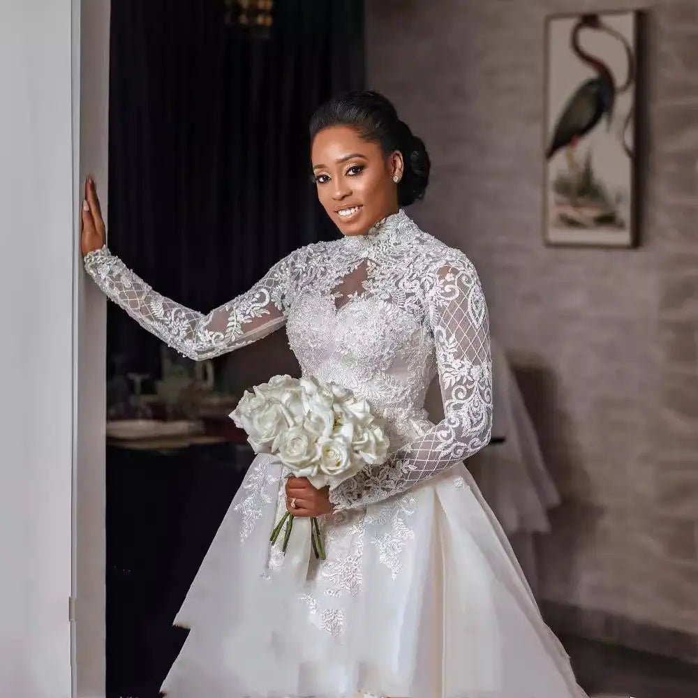 white lace wedding gown featuring a floral lace stand collar with long sleeves and a high neckline designed for bridal wear.