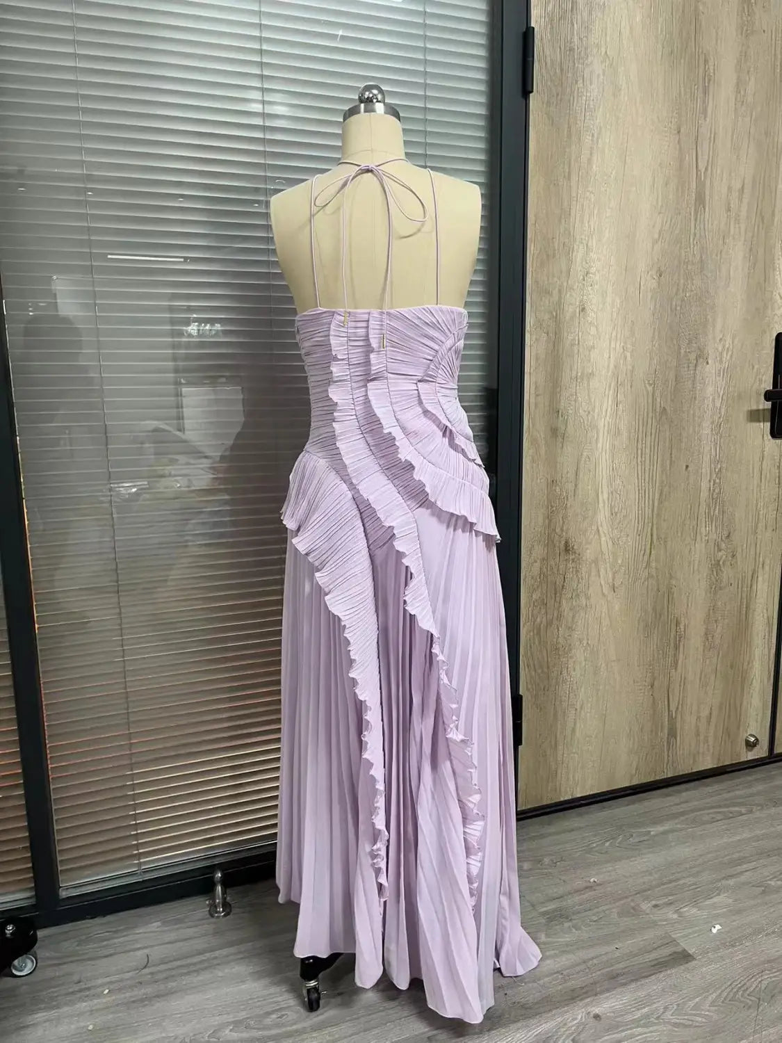 a lavender chiffon asymmetrical ruffled halterneck evening dress featuring a pleated maxi skirt and thin tie-back straps