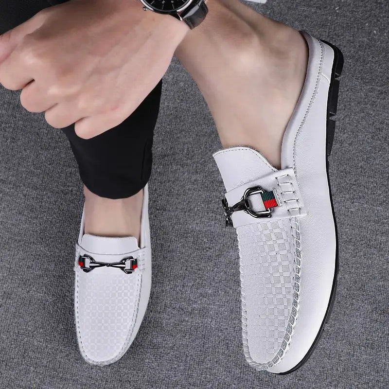 Men’s white leather mule loafers with textured pattern and black metal horsebit buckle accented by red and green stripes.