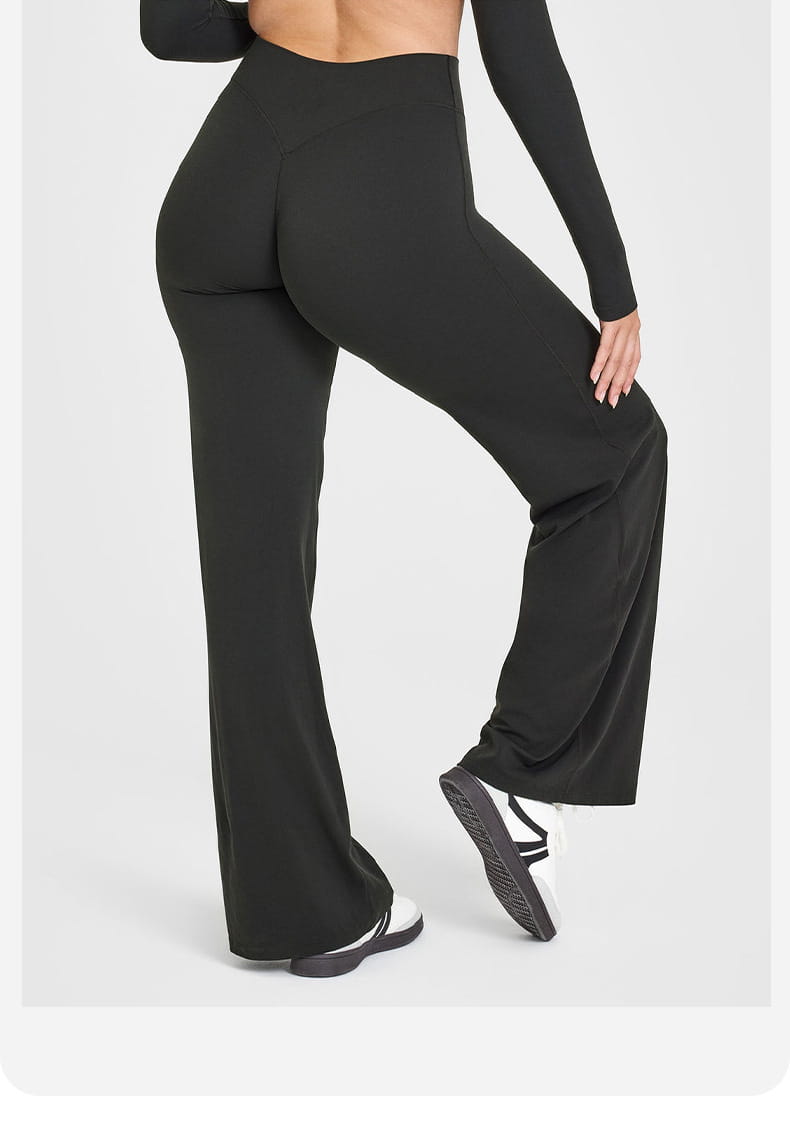 Black high-waisted slimming yoga pants with a straight leg design made from smooth stretchy fabric.