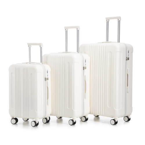 Set of three white abs hard-shell spinner suitcases with vertical ribbed design and silver telescoping handles featuring tsa lock mechanism.
