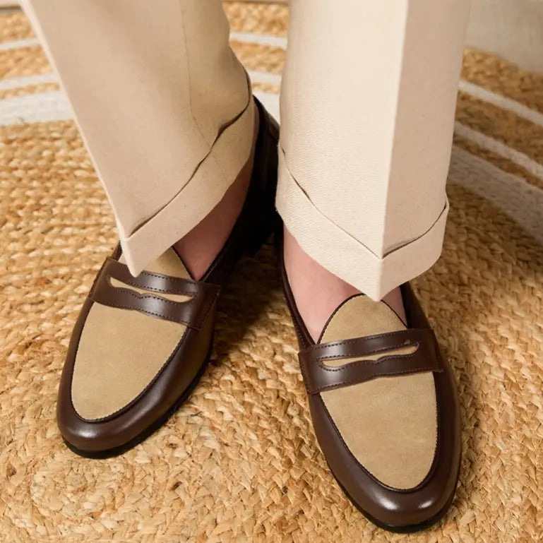 Two tone British style suede loafers in brown and beige feature a classic penny loafer design with a block heel.