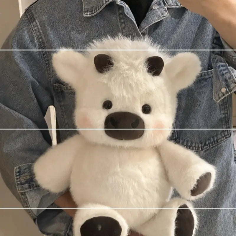 A plush white bear with black ears nose and paw pads featured among plush cow and pig soft stuffed animal toys for kids.