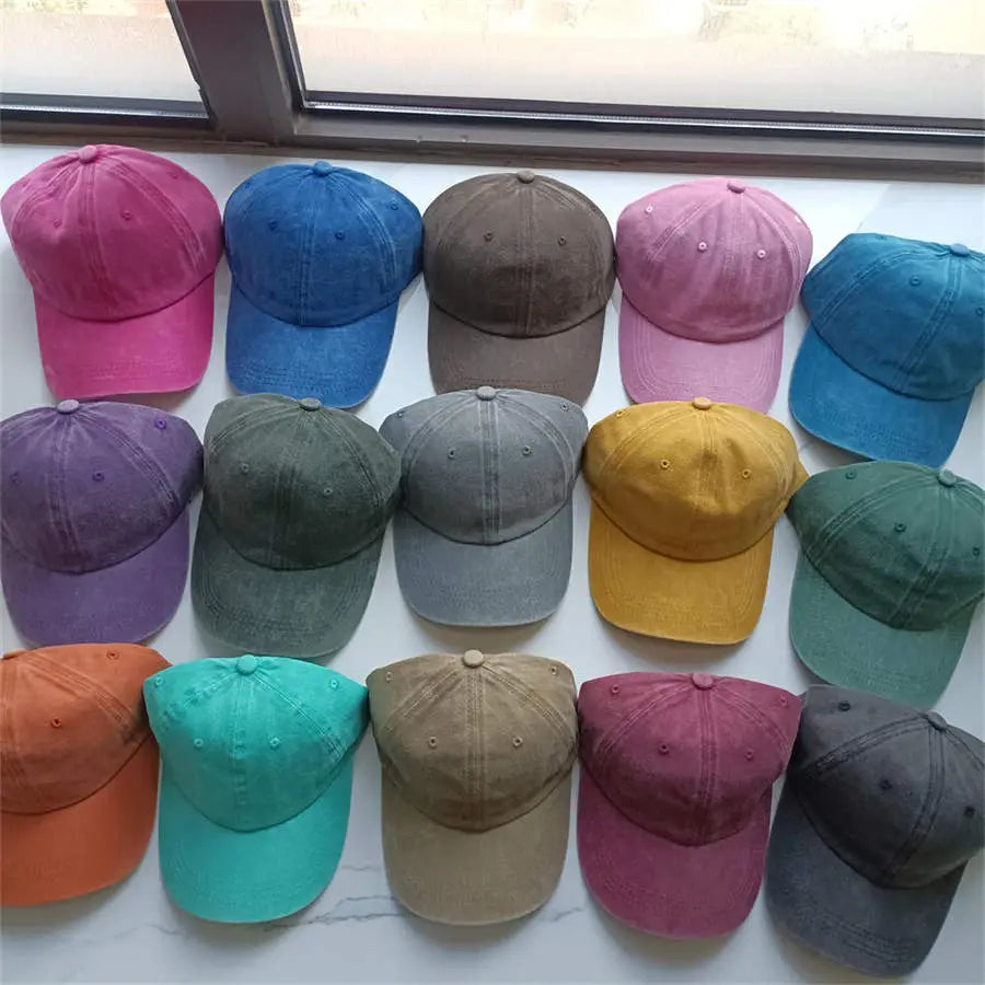 a collection of cotton baseball caps in vintage washed soft texture featuring various colors including pink blue brown purple green yellow orange and teal designed as sun hats