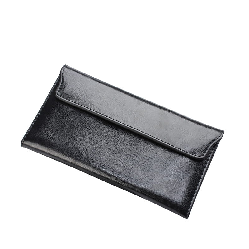 Black leather long wallet slim minimalist cowhide clutch with a smooth slightly textured surface and precise stitching along the edges.