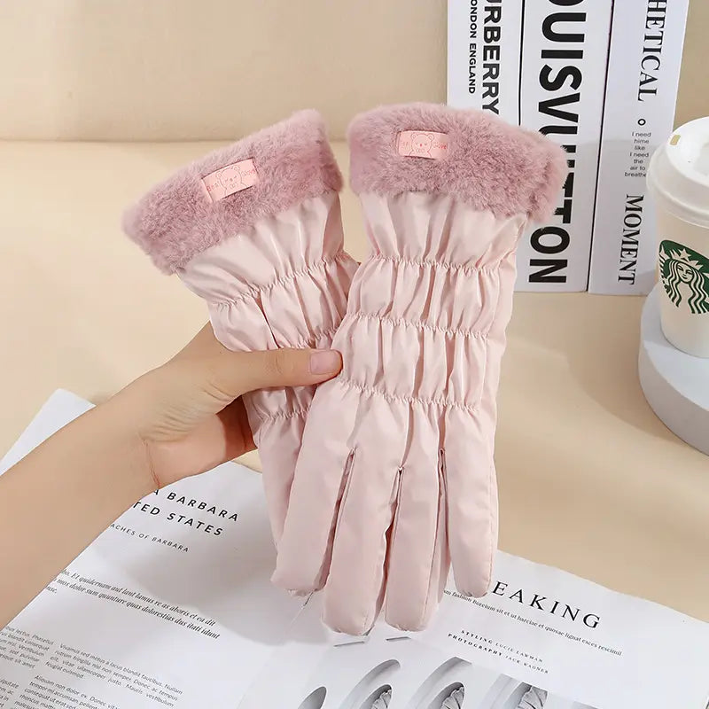 Pink quilted women touch screen winter fleece gloves with fluffy pink faux fur cuffs and a small brand tag on the wrist.