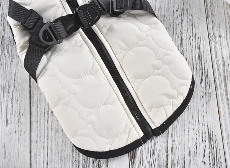 White quilted dog vest with black zipper and adjustable straps designed as a windproof warm pet coat.
