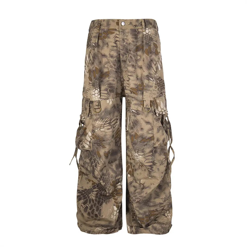 Tan and brown camouflage cargo pants with wide leg tactical trousers featuring multiple pockets and drawstrings.