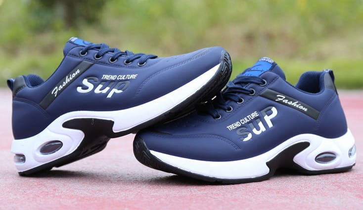 Men’s casual sportswear leather running shoes in navy blue with white and black accents featuring trend culture sup branding on the side.