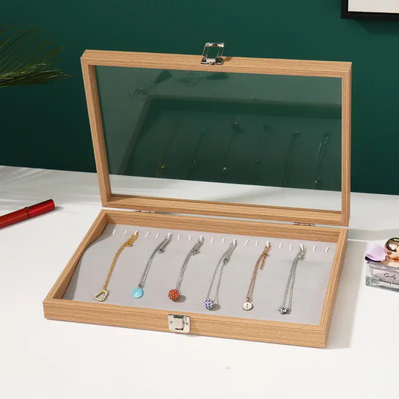 rosewood jewelry display box featuring a light wood construction with a glass lid and silver latch for secure storage.