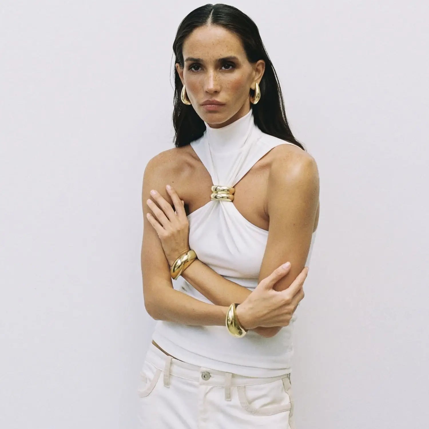 White halter-neck stretch top featuring a gold-toned metallic clasp at the neckline called gold ring halter stretch top.