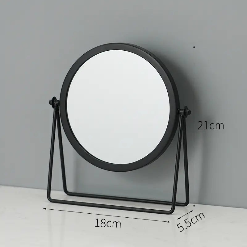 Black circular vanity mirror with a minimalist metal frame and stand designed for makeup and desk use.