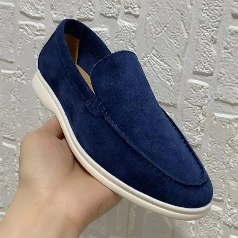 Men’s suede summer loafers in deep blue with a white rubber sole designed as flat casual slip-on shoes.