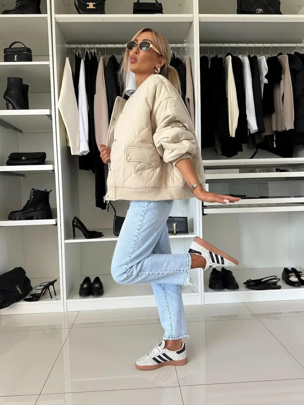 white adidas sneakers with black stripes and tan sole paired with a quilted bomber jacket casual outerwear for stylish comfort