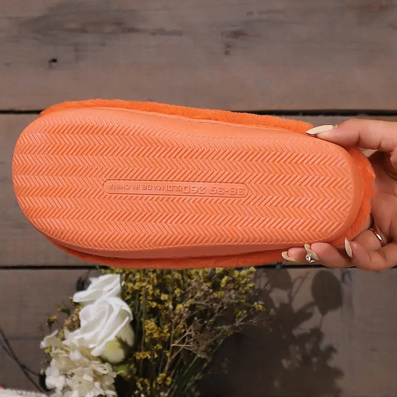 orange fuzzy slipper with textured rubber sole designed as plush pumpkin halloween indoor slipper