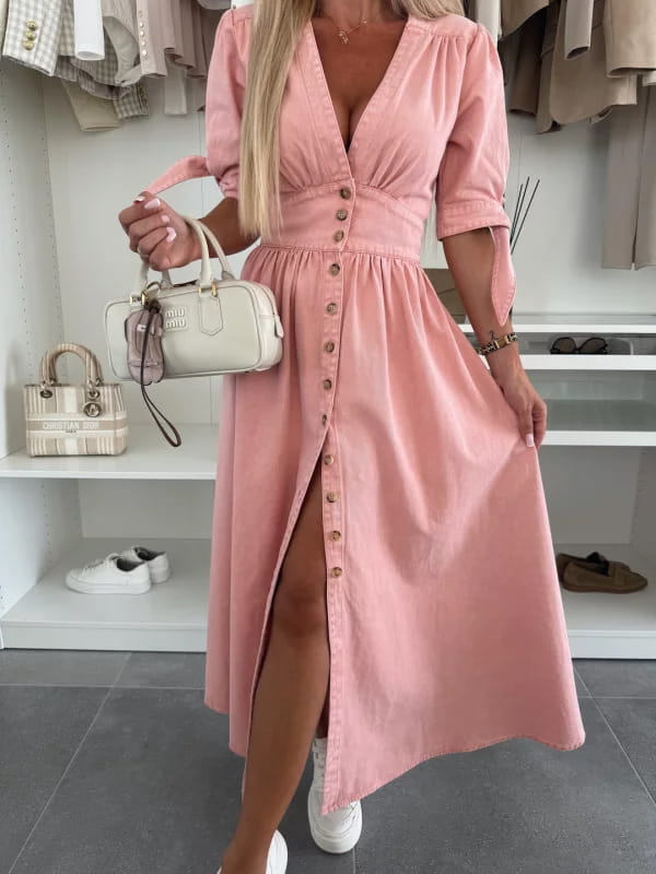pink button-front denim midi dress with puff sleeves and a high slit shown from the front