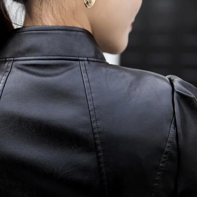 Black faux leather leather moto jacket with high collar and puffed sleeves displayed from the front.