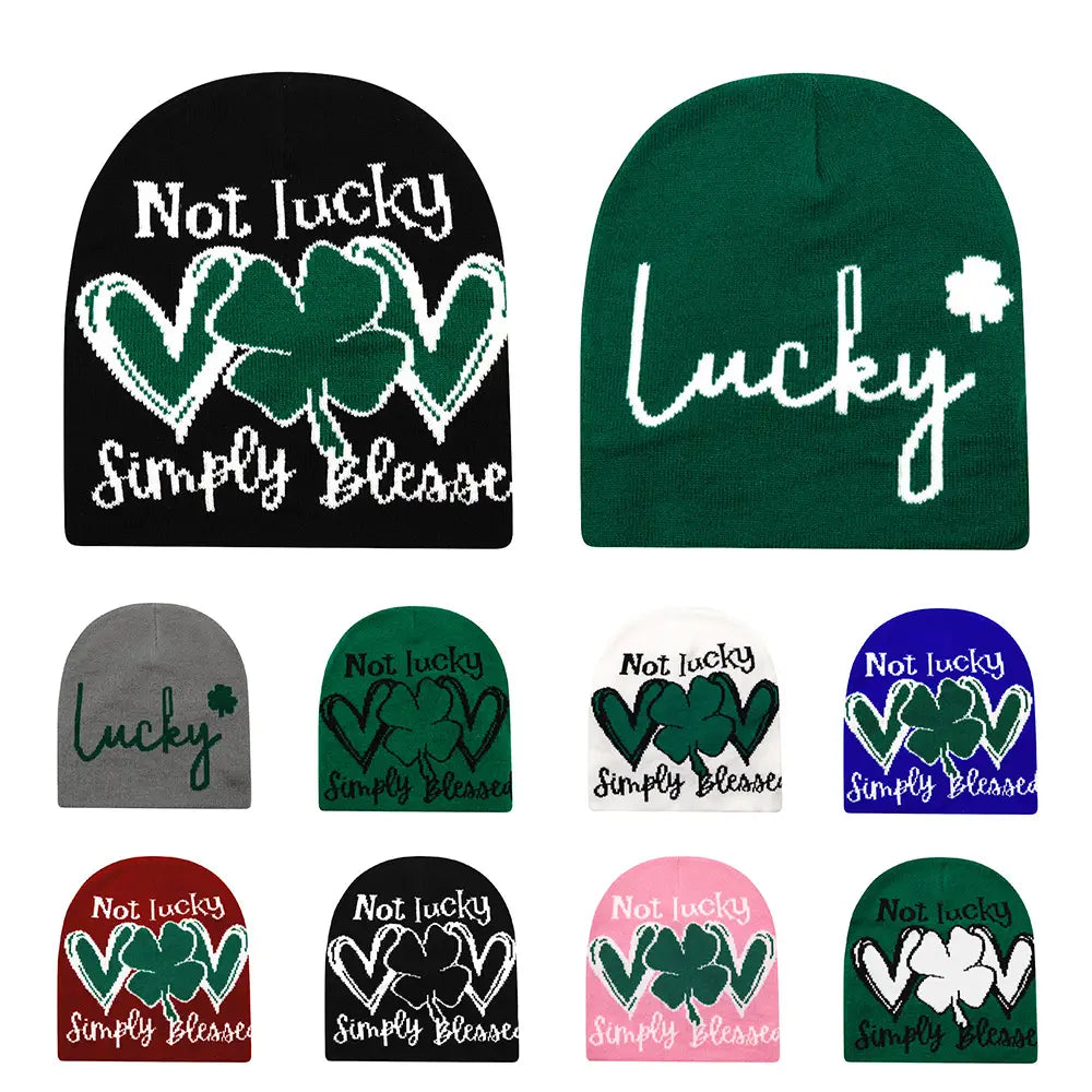 Black and green knitted beanie with white embroidered shamrock design and not lucky simply blessed text for winter warmth.