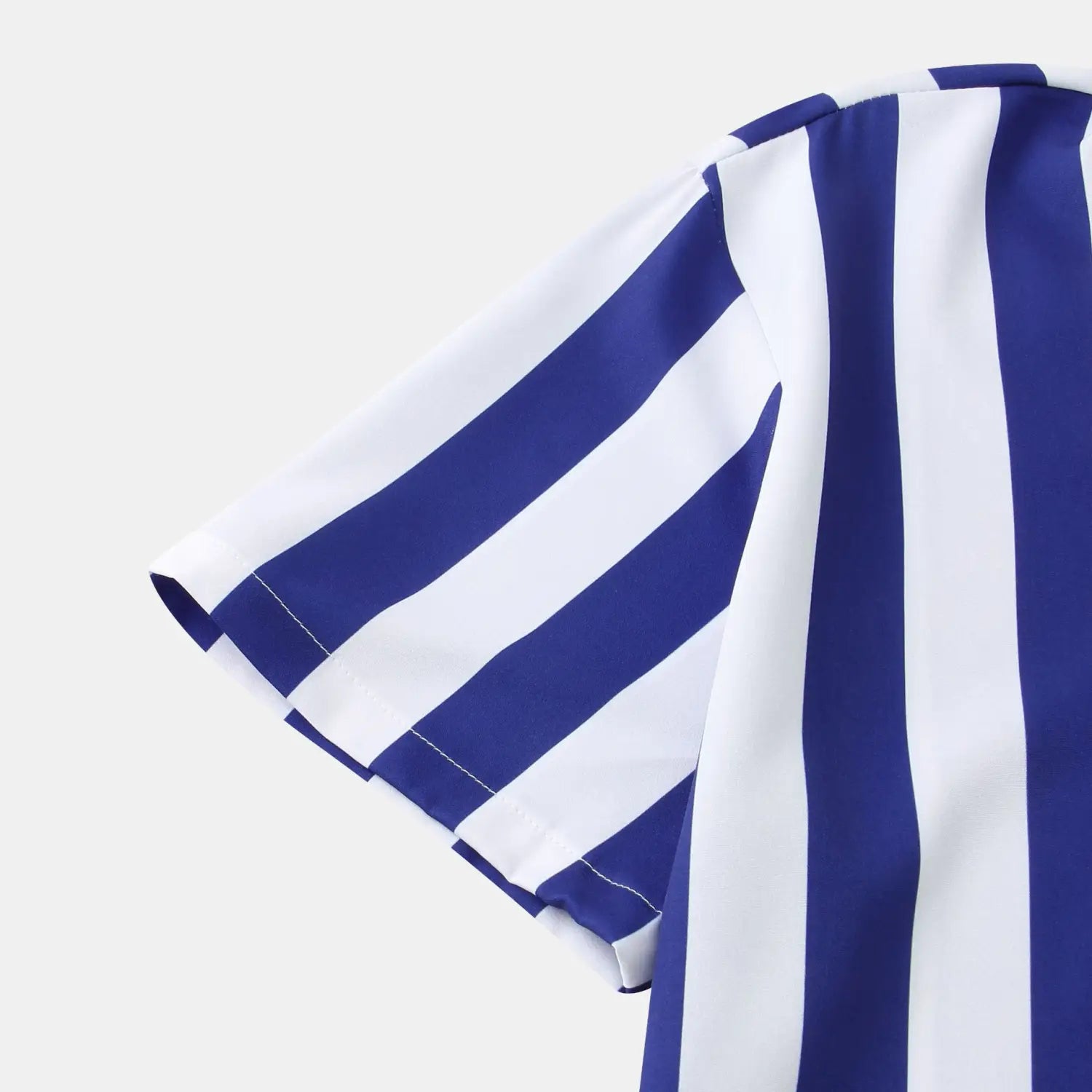 Chemise pour homme à rayures, à manches courtes, boutonnée sur le devant, présentant des rayures verticales bleues et blanches, avec une couture soignée le long de l’ourlet de la manche.