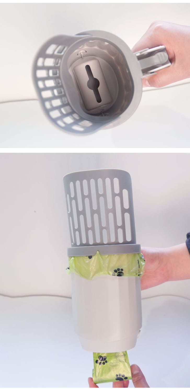 Gray plastic integrated cat litter scoop with perforated top and handle in use over lime green paw printed liner for efficient trash removal.
