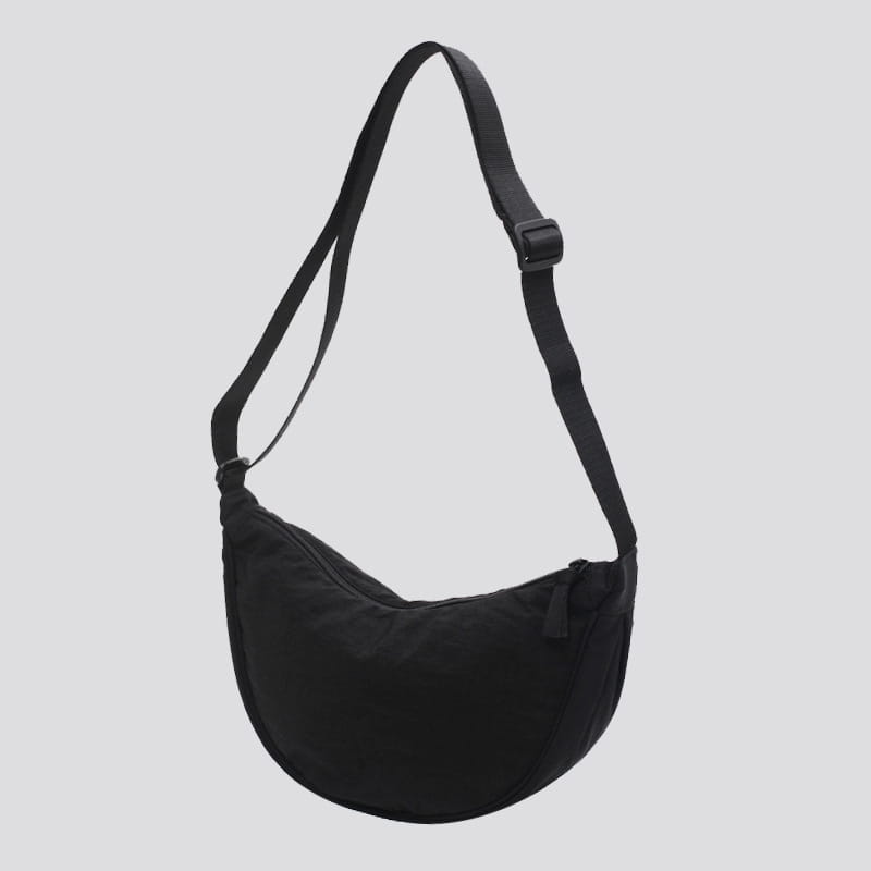 Black nylon dumpling messenger bag with curved adjustable crossbody strap and zipper closure