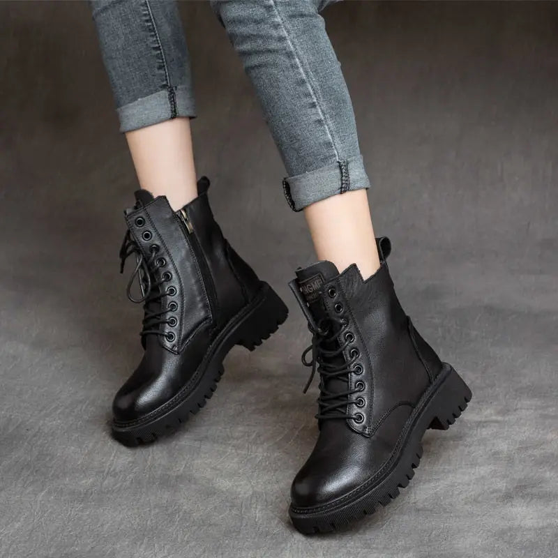 Martin boots women’s leather chunky lace up combat boots in black featuring a chunky sole and side zipper.