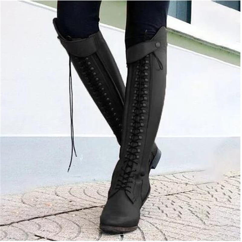 black leather over the knee riding boots with laces and decorative studs shown from the back side
