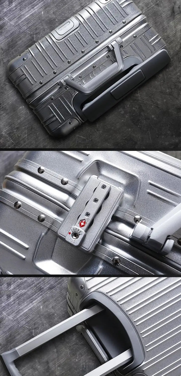 Silver aluminum magnesium luggage hardshell spinner suitcase with ribbed texture and retractable handle.