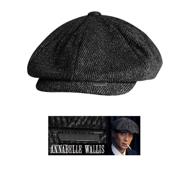 A dark gray herringbone woolen octagonal flat cap with a structured eight-panel design and a small metallic tag on the front.