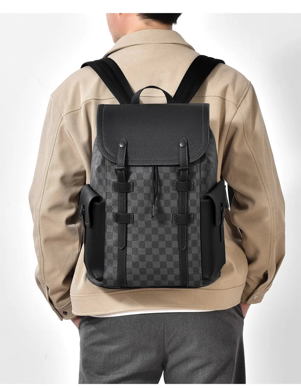Black leather men’s business travel backpack with checkered pattern and leather straps featuring a laptop sleeve.