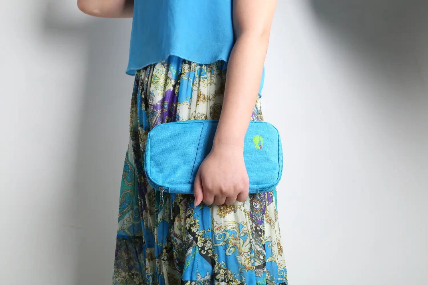 Bright blue rectangular waterproof oxford fabric travel passport and document wallet with a subtle green logo on the front.