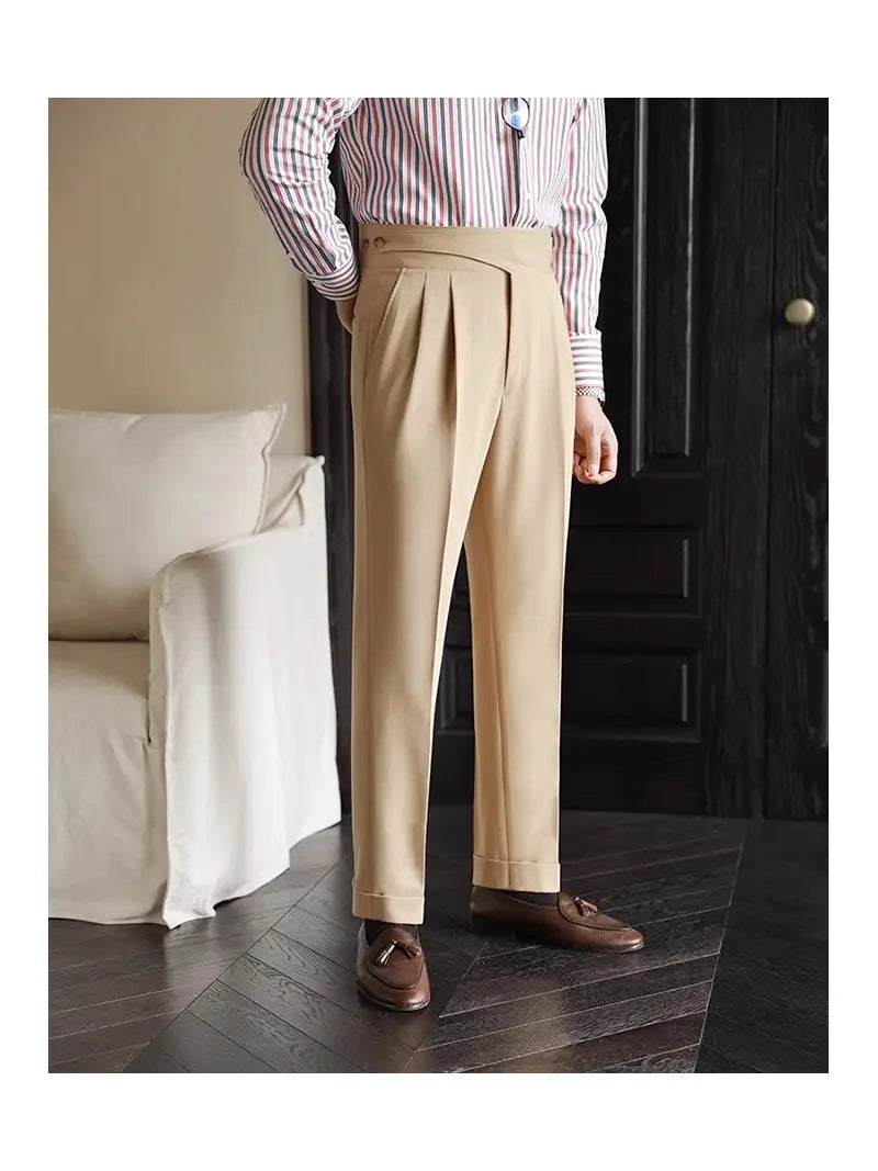 Beige tailored pleated wool straight leg trousers with a tailored fit and rolled cuffs for men.