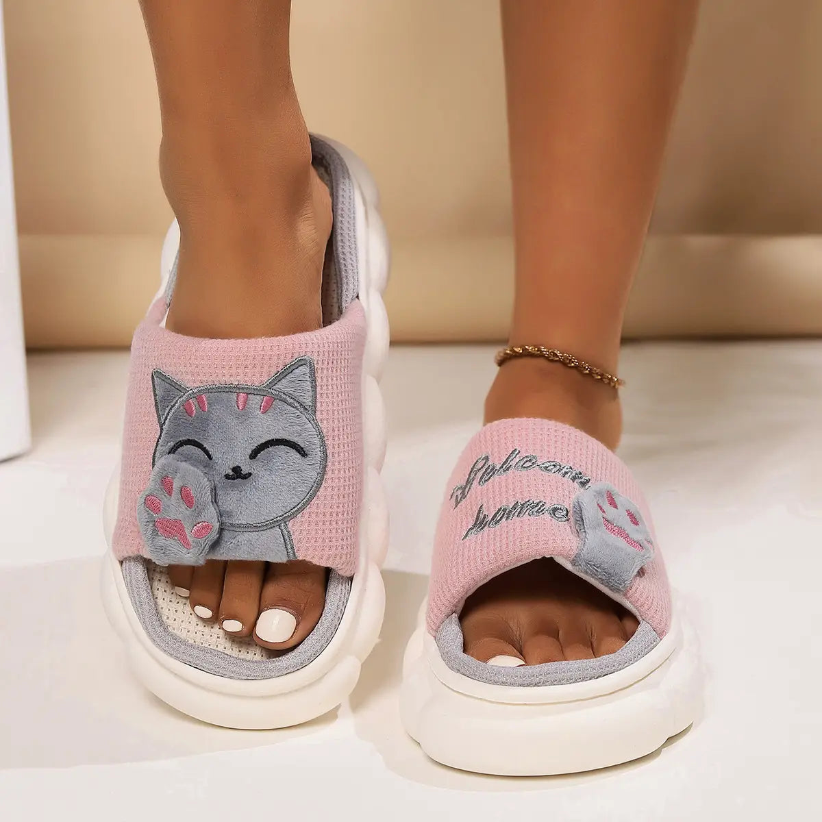 pink and gray embroidered cat cartoon unisex anti slip slide slippers with a plush textured upper and chunky white soles