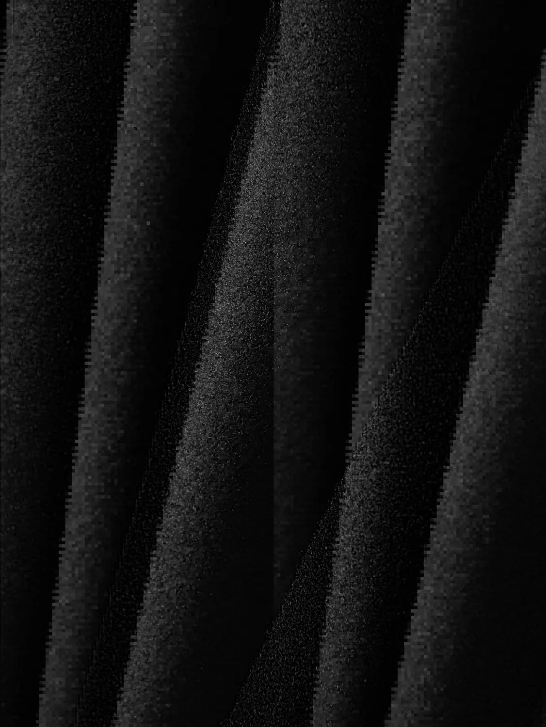 Black textured fabric with a soft plush appearance featured on a men’s classic slim fit wool blend lapel jacket.