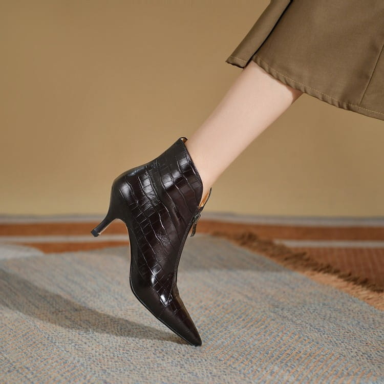 Black crocodile embossed leather ankle boot with a slender stiletto heel and pointed toe.